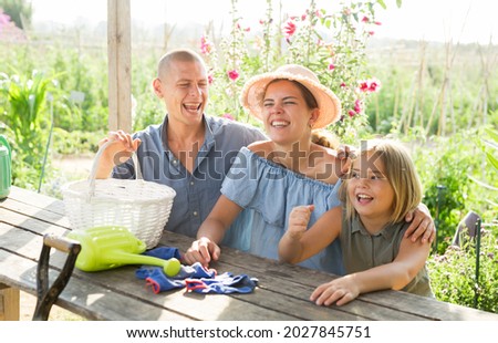 Parents and their daughter spending time together in their garden