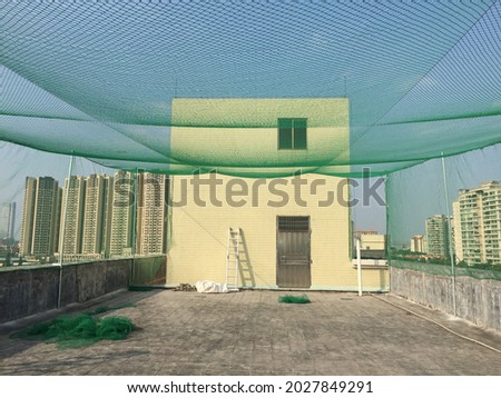 Baseball batting cage on the top of building.