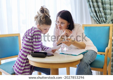 Pre-adolescent girl at consultation with social worker in office Royalty-Free Stock Photo #2027853296