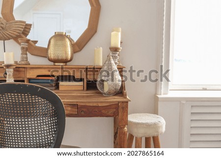 modern interior of a bright room with decorative items in bali style, white walls, wood floors and vintage furniture Royalty-Free Stock Photo #2027865164