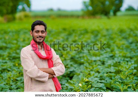 Young Indian farmer at green agriculture field. Royalty-Free Stock Photo #2027885672
