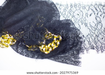 Black lace on a white background. black lace trim around the yard. fabric for underwear. crochet trim. your design. postcard invitation. texture background pattern. golden chain