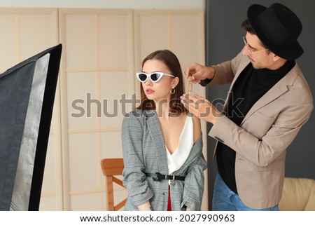 Male stylist working with model in studio