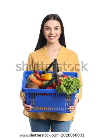 Young woman with shopping basket on white background