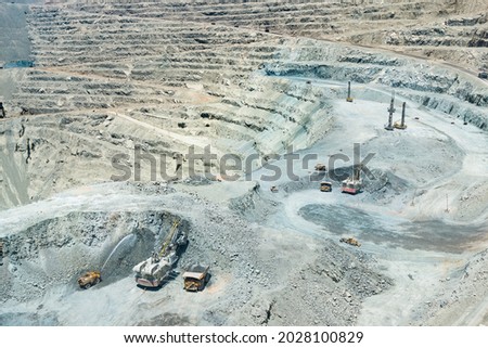 Electric rope shovel loading a dump trucks at a copper mine in Chile