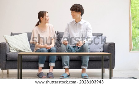 young asian couple talking in the living room