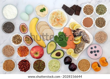 Bipolar disorder and manic depression mood stabilising health food high in omega 3, protein, selenium, magnesium, vitamins, serotonin, tryptophan. Variety of foods, natural herbal medicine concept.   Royalty-Free Stock Photo #2028156644