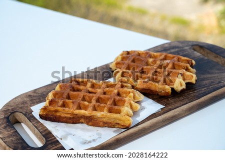 Belgian sugar waffles served on outdoor cafe terrace close up