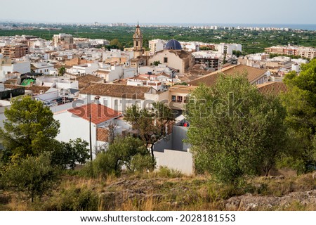 Top view on old city of Oliva with the church tower and blue dome of 'Santa Maria la Mayor' from the 17th century reaching out, Spain
