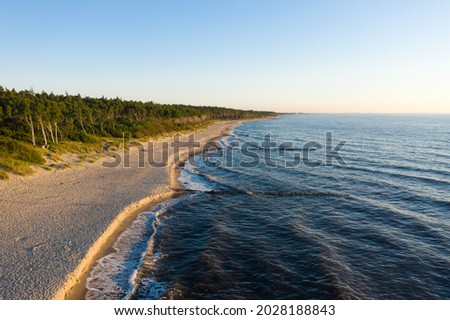 Curonian Spit wth Baltic sea coastline on sunset. Kurshskaya kosa national park near Zelenogradsk. Kaliningrad region. Aerial view Royalty-Free Stock Photo #2028188843