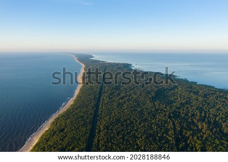 Curonian Spit wth Baltic sea coastline on sunset. Kurshskaya kosa national park near Zelenogradsk. Kaliningrad region. Aerial view Royalty-Free Stock Photo #2028188846
