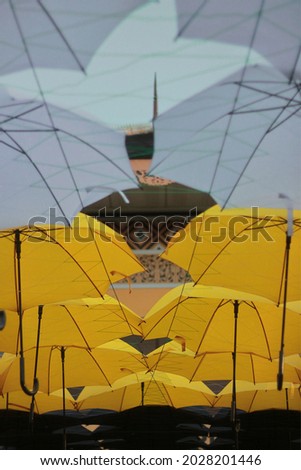 Black, yellow and white umbrella made into roof-like decoration, pictured vertically at a traditional house display in Malaysia Agro Exposition Park Serdang