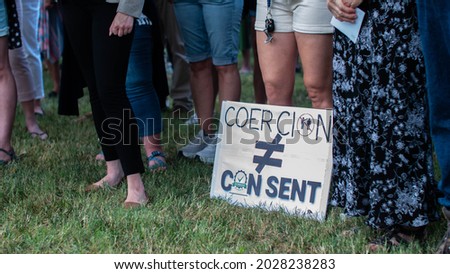 Coercion does not equal consent protest sign laid at feet of protesters