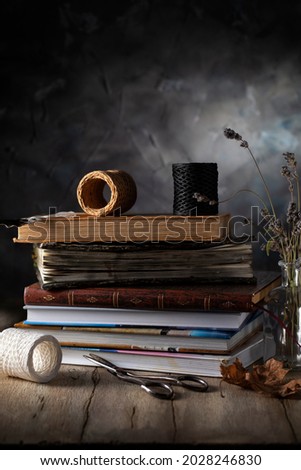 Stack of books and lavender on wooden table