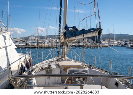 Moored nautical vessels at sea port San Antonio de Portmany, Balearic Islands, Ibiza, Spain. Sunny spring day.