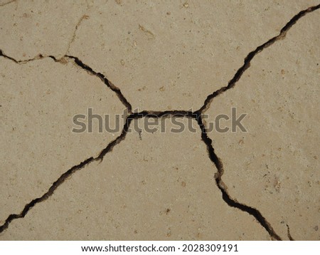 a close up photograph of cracks over the ground