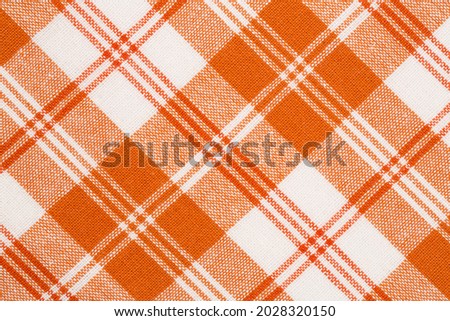 Orange and white kitchen towels texture as a background, vertical picture.
