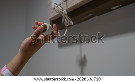 Photo of hand pressing Nurse call button in hospital