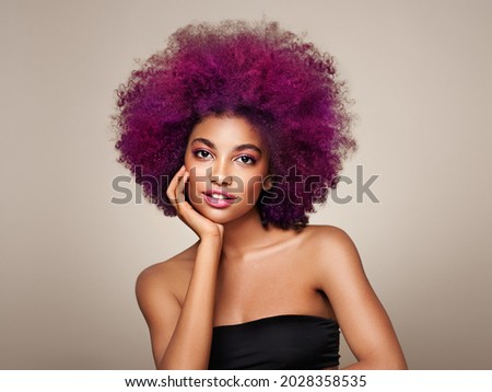 Beauty portrait of African American girl with colorful dyed afro hair. Beautiful black woman. Cosmetics, makeup and fashion Royalty-Free Stock Photo #2028358535