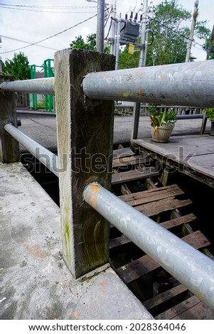 Photo of a road guardrail designed from cement and iron pipes for the safety of road users and vehicles. This photo is suitable for construction, road safety, transportation etc Royalty-Free Stock Photo #2028364046