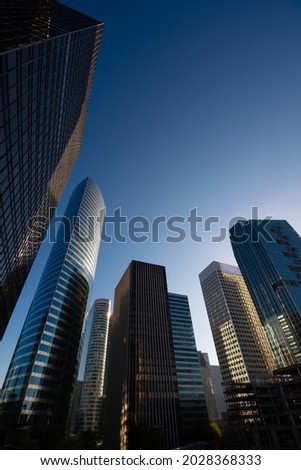 Modern glass and steel office towers located in the international business and finance district of Paris-La Défense, France. Copy space for text