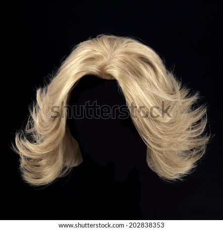 female blonde wig on a black background Royalty-Free Stock Photo #202838353