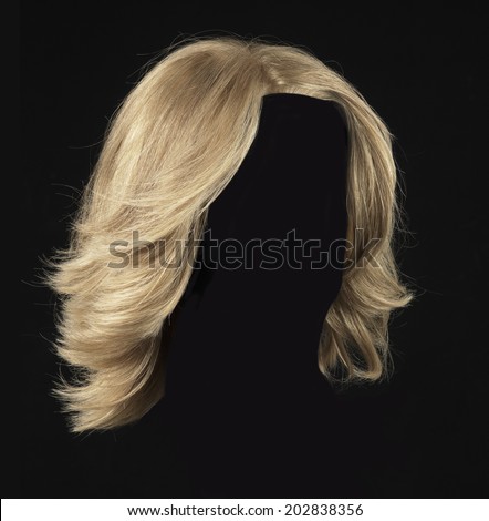 female blonde wig on a black background Royalty-Free Stock Photo #202838356