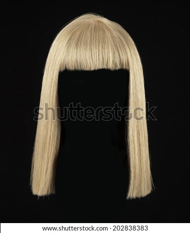 female blonde wig on a black background Royalty-Free Stock Photo #202838383