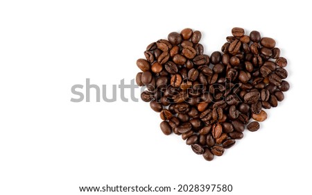 Heart from coffee beans. Coffee beans in heart shape white background isolated. a photo of coffee beans arranged in a heart of Valentine's Day on a white background. flat lay. top view. Royalty-Free Stock Photo #2028397580
