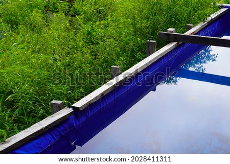This photo is about a rainwater collection container that is installed outdoors. This photo is suitable for your commercial needs around environment, climate change, clean water crisis, water storage Royalty-Free Stock Photo #2028411311