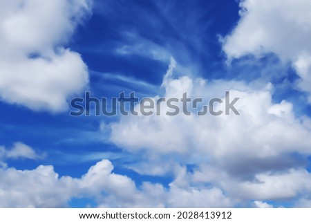 Blue sky with white cumulus clouds beautiful nature Blurred nature abstract background with blue gradient on a summer day. space for text.