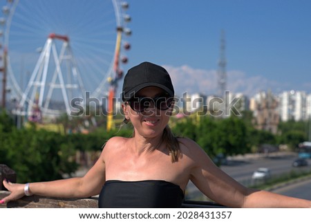 
Girl posing on the background of the largest ferris wheel in Turkey