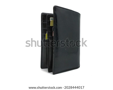 Women's Wallet Made Of Cow Leather Has A Black Color. Women's Wallet For Money And Various Credit Cards, Shopping Cards And Atm Cards. Photo Of Women's Wallet For Finance Or Shopping Concept.
