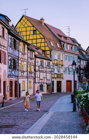 Colmar, Alsace, France. Petite Venice, water canal, and traditional half timbered houses. Colmar is a charming town in Alsace, France. couple man and women walking at the street during vacation