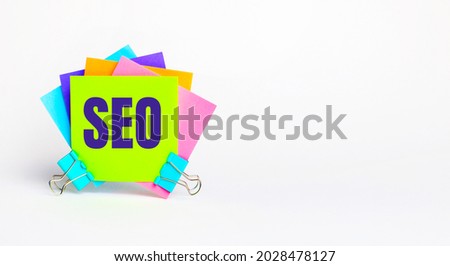 There are bright multi-colored stickers with the text SEO Search Engine Optimization. Copy space