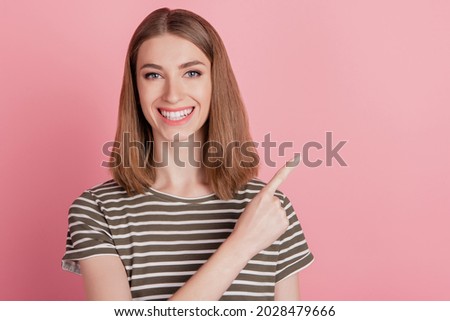 Portrait of pretty reliable promoter lady indicate forefinger empty space on pink background