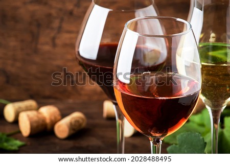 Wine tasting. Red, white, rose - still wines sin glasses on vintage wooden table background