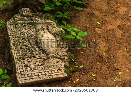 Ancient carved stone in the ground at Wat Umong Suan Puthatham is a Buddhist temple is a major tourist attraction with green forest nature in Chiang Mai,Thailand.