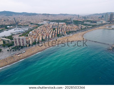 Aerial view of La Barceloneta, in Barcelona, central beach district in catalonia. Aerial view of mediterranean sea, beach, port and cityscape. Birds eye of Sant Miquel Sebastian plage. Spain drone.