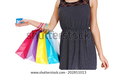 A young woman holding her shopping four bag's and a credit card  a closeup picture of her body, isolated over white background. 