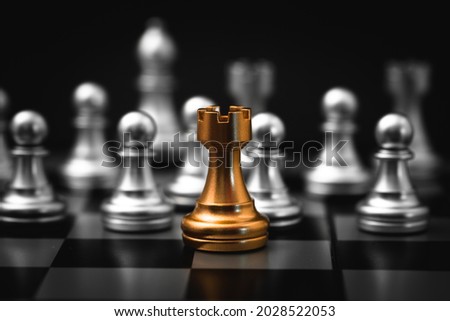 Gold Rook or Castle Tower Chess piece closeup on chess board game. Elite Company leader concept. Royalty-Free Stock Photo #2028522053