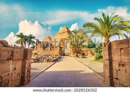 Luxor Karnak temple. The pylon with blue sky and pyramids Royalty-Free Stock Photo #2028526502