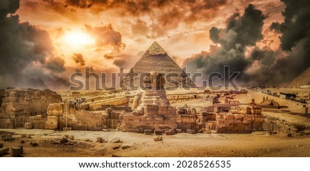 Great sphinx and pyramid and storm clouds Royalty-Free Stock Photo #2028526535
