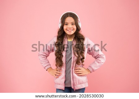 Fun and entertainment. Modern lifestyle. Music gives joy. Happy child listen to music pink background. Little girl wear headphones playing music. New technology for kids
