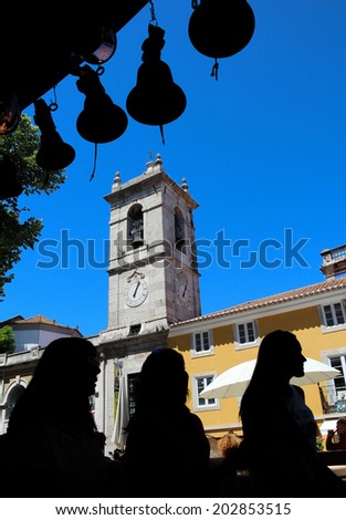 Unknown tourists with church tower in the background seen in Sintra, Portugal