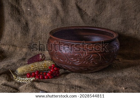 

Beautiful elegant Ukrainian folk ceramics. Still life of utensils, vegetables and fruits. Designer tableware for the interior.