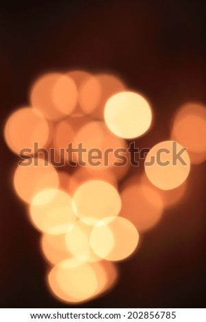 Gold Festive Christmas background. Elegant abstract background with bokeh defocused lights and stars 