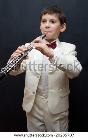 Portrait of the young musician on a dark background.