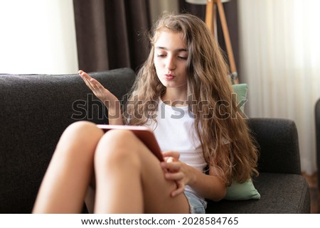 youtuber teenage girl making videos for his followers. Adolescent girl using a tablet.
