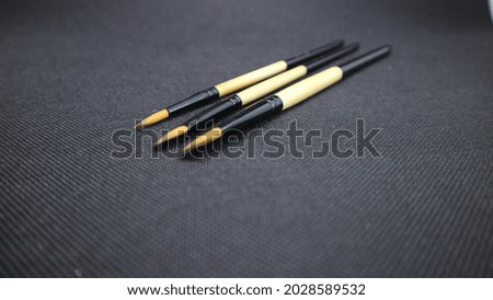 close up paintbrush isolated on black background